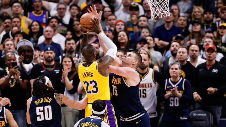 Apr 29, 2024; Denver, Colorado, USA; Los Angeles Lakers forward LeBron James (23) drives to the basket as Denver Nuggets center Nikola Jokic (15) defends in the fourth quarter during game five of the first round for the 2024 NBA playoffs at Ball Arena. Mandatory Credit: Isaiah J. Downing-USA TODAY Sports