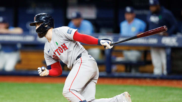 May 22, 2024; St. Petersburg, Florida, USA;  Boston Red Sox catcher Connor Wong (12) hits a two rbi single against the Tampa Bay Rays in the fifth inning at Tropicana Field. Mandatory Credit: Nathan Ray Seebeck-USA TODAY Sports