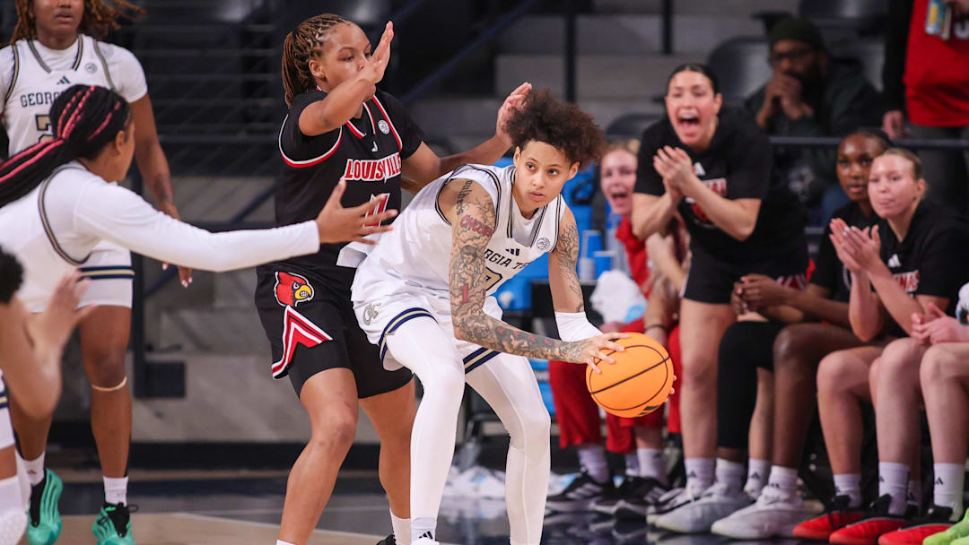 Feb 26, 2026; Atlanta, Georgia, USA; Georgia Tech Yellow Jackets guard Brianna Turnage (0) is defended by Louisville Cardinals forward MacKenly Randolph (4) in the second quarter at McCamish Pavilion. Mandatory Credit: Brett Davis-Imagn Images