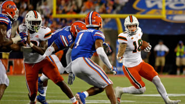 Aug 24, 2019; Orlando, FL, USA; Miami Hurricanes quarterback Tate Martell (18) runs the ball against the Florida Gators during the second half at Camping World Stadium. Mandatory Credit: Jasen Vinlove-USA TODAY Sports