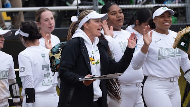 Oregon coach Melyssa Lombardi celebrates as the Ducks widen the score in the fifth inning against Stanford.