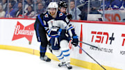 Oct 28, 2024; Winnipeg, Manitoba, CAN;  Winnipeg Jets forward Kyle Connor (81) skates away from Toronto Maple Leafs defensemen Simon Benoit (2) during the second period at Canada Life Centre. Mandatory Credit: Terrence Lee-Imagn Images