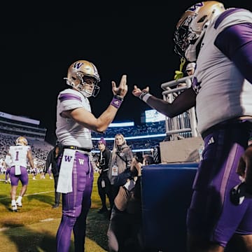 Will Rogers and Jeremiah Hunter trade hand slaps in Rogers' next-to-last game as the Husky starter. 