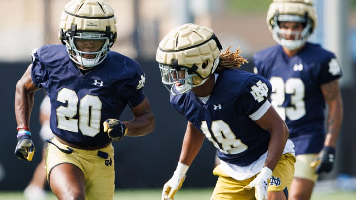 Notre Dame football cornerbacks Benjamin Morrison (20) and Chance Tucker (18) participate in a drill