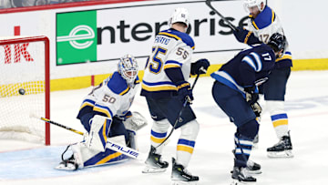 May 4, 2025; Winnipeg, Manitoba, CAN; Winnipeg Jets center Adam Lowry (17) scores a goal against St. Louis Blues goaltender Jordan Binnington (50) in the second overtime of game seven of the first round of the 2025 Stanley Cup Playoffs at Canada Life Centre. Mandatory Credit: James Carey Lauder-Imagn Images