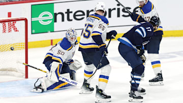 May 4, 2025; Winnipeg, Manitoba, CAN; Winnipeg Jets center Adam Lowry (17) scores a goal against St. Louis Blues goaltender Jordan Binnington (50) in the second overtime of game seven of the first round of the 2025 Stanley Cup Playoffs at Canada Life Centre. Mandatory Credit: James Carey Lauder-Imagn Images