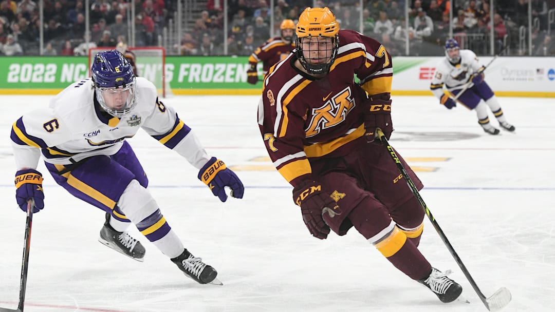 Minnesota forward Aaron Huglen shakes with the puck against Minnesota State forward Sam Morton (6) during the second period of the Frozen Four semifinals at the TD Garden in Boston on April 7, 2022.