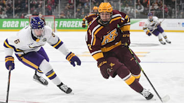 Minnesota forward Aaron Huglen shakes with the puck against Minnesota State forward Sam Morton (6) during the second period of the Frozen Four semifinals at the TD Garden in Boston on April 7, 2022.