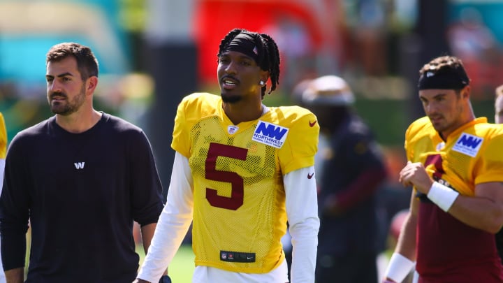 Aug 15, 2024; Miami Gardens, FL, USA; Washington Commanders quarterback Jayden Daniels (5) looks on during joint practice with the Miami Dolphins at Baptist Health Training Complex. Mandatory Credit: Sam Navarro-USA TODAY Sports