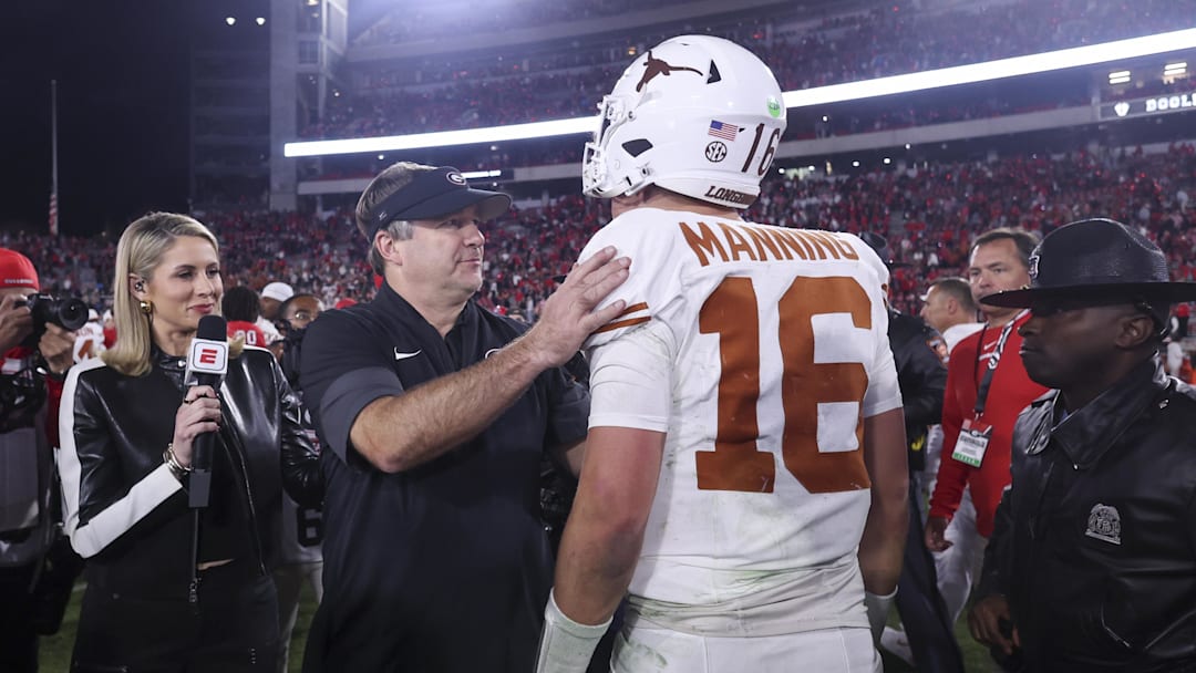 Georgia Bulldogs head coach Kirby Smart and Texas Longhorns quarterback Arch Manning (16) interact after a game at Sanford Stadium.