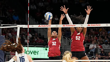 Wisconsin Badgers outside hitter Grace Egan (32) and middle blocker Carter Booth (52) block the hit from Marquette Golden Eagles outside hitter Ella Holmstrom (16) during the first set of the match on Wednesday September 17, 2025 at Fiserv Forum in Milwaukee, Wisconsin.