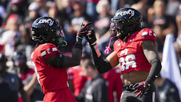 Oct 11, 2025; Cincinnati, Ohio, USA; Cincinnati Bearcats defensive back Jiquan Sanks (9) celebrates a play with safety Xavier Williams (36) in the game against the UCF Knights in the second half at Nippert Stadium. Mandatory Credit: Aaron Doster-Imagn Images