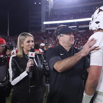 Georgia Bulldogs head coach Kirby Smart and Texas Longhorns quarterback Arch Manning (16) interact after a game at Sanford Stadium.