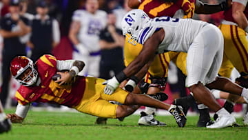 Nov 7, 2025; Los Angeles, California, USA; Southern California Trojans quarterback Jayden Maiava (14) falls as Northwestern Wildcats defensive lineman Najee Story (95) moves in during the first half at the Los Angeles Memorial Coliseum. Mandatory Credit: Gary A. Vasquez-Imagn Images
