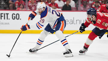 Edmonton Oilers center Leon Draisaitl battles for the puck against Florida Panthers forward Matthew Tkachuk.