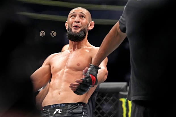 Khamzat Chimaev (red gloves) fights Kevin Holland (blue gloves) during UFC 279 at T-Mobile Arena. 