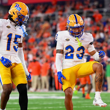 Oct 18, 2025; Syracuse, New York, USA; Pittsburgh Panthers defensive back Kavir Bains (23) celebrates his interception with teammate defensive back Rashad Battle (15) against the Syracuse Orange during the second half at the JMA Wireless Dome. Mandatory Credit: Rich Barnes-Imagn Images