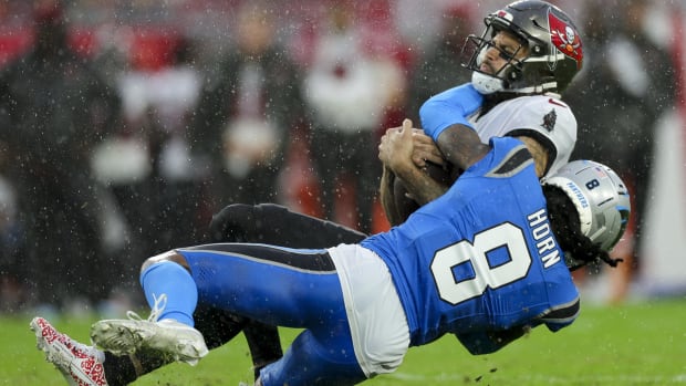 Tampa Bay Buccaneers wide receiver Mike Evans (13) is tackled by Carolina Panthers cornerback Jaycee Horn (8)