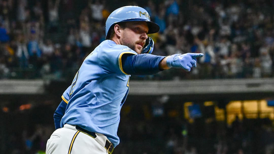 Sep 27, 2024; Milwaukee, Wisconsin, USA;  Milwaukee Brewers first baseman Rhys Hoskins (12) reacts after hitting a grand slam home run against the New York Mets in the first inning at American Family Field. Mandatory Credit: Benny Sieu-Imagn Images