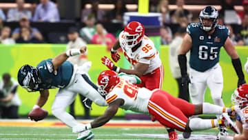Feb 9, 2025; New Orleans, LA, USA; Philadelphia Eagles quarterback Jalen Hurts (1) is tackled by Kansas City Chiefs defensive tackle Tershawn Wharton (98) in the second quarter in Super Bowl LIX at Ceasars Superdome. Mandatory Credit: Mark J. Rebilas-Imagn Images