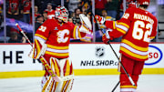 Nov 15, 2024; Calgary, Alberta, CAN; Calgary Flames goaltender Dustin Wolf (32) celebrate win with teammates after defeating Nashville Predators at Scotiabank Saddledome. Mandatory Credit: Sergei Belski-Imagn Images