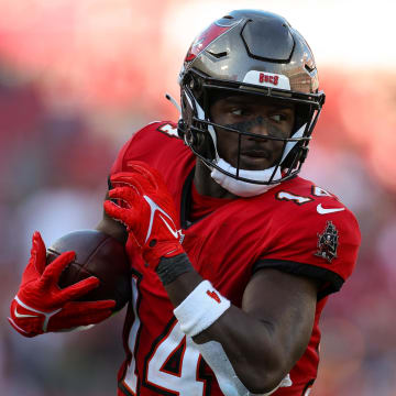 Dec 31, 2023; Tampa, Florida, USA;  Tampa Bay Buccaneers wide receiver Chris Godwin (14) catches a pass for a touchdown against the New Orleans Saints in the fourth quarter at Raymond James Stadium. Mandatory Credit: Nathan Ray Seebeck-USA TODAY Sports