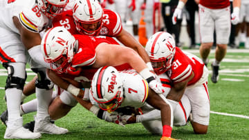 Nov 11, 2023; Lincoln, Nebraska, USA; Maryland Terrapins running back Antwain Littleton II (7) is stopped short of a first down on a fourth down play by Nebraska Cornhuskers defensive lineman Nash Hutmacher (0), linebacker Javin Wright (33), and defensive back Tommi Hill (31) during the third quarter at Memorial Stadium.