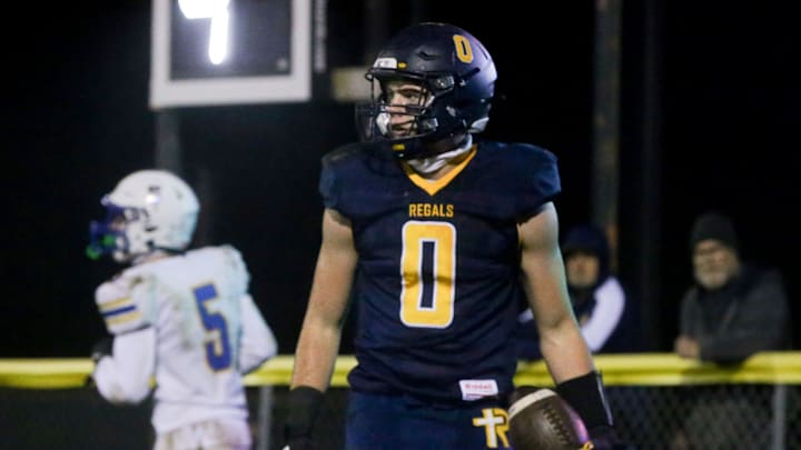 Tate Wallace (0) holds the football in the endzone after scoring a touchdown against Wilton during an IHSAA football quarterfinal Friday, Nov. 8, 2024 in Iowa City, Iowa.