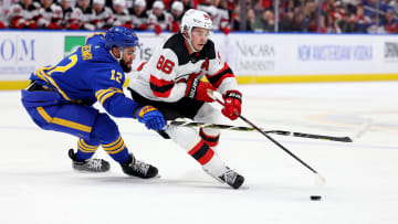 Mar 29, 2024; Buffalo, New York, USA;  New Jersey Devils center Jack Hughes (86) carries the puck as Buffalo Sabres left wing Jordan Greenway (12) tries to defend during the first period at KeyBank Center. Mandatory Credit: Timothy T. Ludwig-USA TODAY Sports