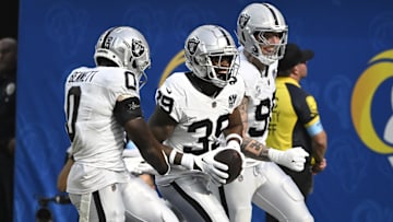 Oct 20, 2024; Inglewood, California, USA; Las Vegas Raiders cornerback Nate Hobbs (39) celebrates intercepting a Los Angeles Rams quarterback Matthew Stafford (not pictured) pass during the third quarter at SoFi Stadium. Left is Las Vegas Raiders cornerback Jakorian Bennett (0), right is defensive end Maxx Crosby (98). Mandatory Credit: Robert Hanashiro-Imagn Images