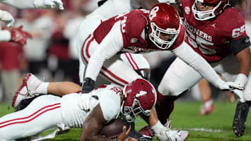 Oklahoma defensive lineman Ethan Downs (40) brings down Alabama quarterback Jalen Milroe (4) during their game at Gaylord Family - Oklahoma Memorial Stadium in Norman, Okla., Saturday, Nov. 23, 2024.