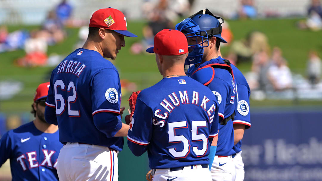 Texas Rangers manager Skip Schumaker (55) stands on the mound as he removes pitcher Robert Garcia (62).