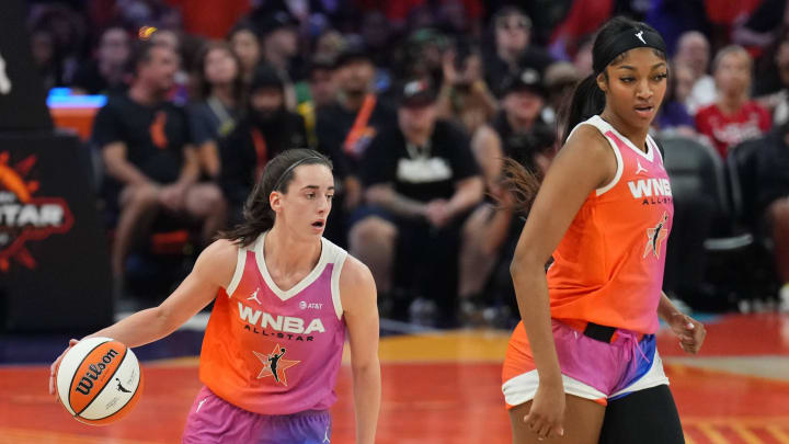 Jul 20, 2024; Phoenix, AZ, USA; Team WNBA guard Caitlin Clark (22) dribbles alongside Team WNBA forward Angel Reese (5) against USA Women's National Team during the WNBA All Star Game at Footprint Center. 