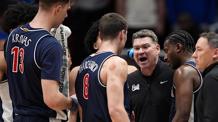 Feb 9, 2026; Lawrence, Kansas, USA; Arizona Wildcats head coach Tommy Lloyd talks to players during the first half against the Kansas Jayhawks at Allen Fieldhouse. Mandatory Credit: Jay Biggerstaff-Imagn Images
