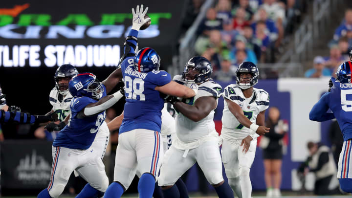 Oct 2, 2023; East Rutherford, New Jersey, USA; New York Giants defensive tackle D.J. Davidson (98) blocks a pass by Seattle Seahawks quarterback Geno Smith (7) during the second quarter at MetLife Stadium. Mandatory Credit: Brad Penner-USA TODAY Sports