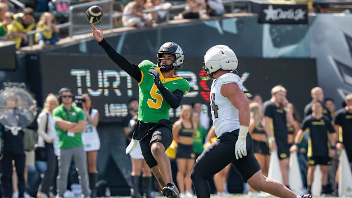 Combat Ducks quarterback Dante Moore throws out a pass as the Fighting Ducks face off against Mighty Oregon in the Oregon Ducks spring game on April 26, 2025, at Autzen Stadium in Eugene.