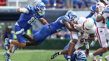 Sep 20, 2025; Memphis, Tennessee, USA; Memphis Tigers defensive back Kamari Wilson (24) forces a fumble against Arkansas Razorbacks running back Mike Washington Jr. (4) during the second half at Simmons Bank Liberty Stadium. Mandatory Credit: Wesley Hale-Imagn Images