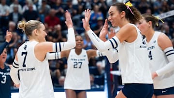 Penn State women's volleyball right side hitter Kennedy Martin high-fives setter Addie Lyon after a point during a Big Ten volleyball match against UCLA