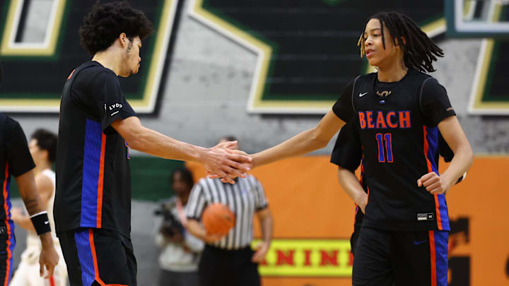 Jan 2, 2026; Mesa, AZ, USA; Rainier Beach High School (WA) forward Tyran Stokes (4) celebrates a play with guard J.J. Crawford (11) against Mater Dei during the HoopHall West Tournament at Skyline High School. Mandatory Credit: Mark J. Rebilas-Imagn Images