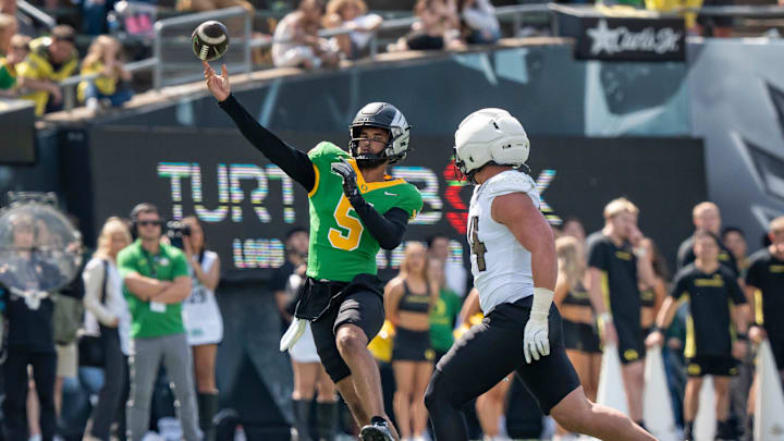 Combat Ducks quarterback Dante Moore throws out a pass as the Fighting Ducks face off against Mighty Oregon in the Oregon Ducks spring game on April 26, 2025, at Autzen Stadium in Eugene.