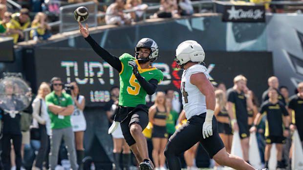 Combat Ducks quarterback Dante Moore throws out a pass in the Oregon Ducks spring game.