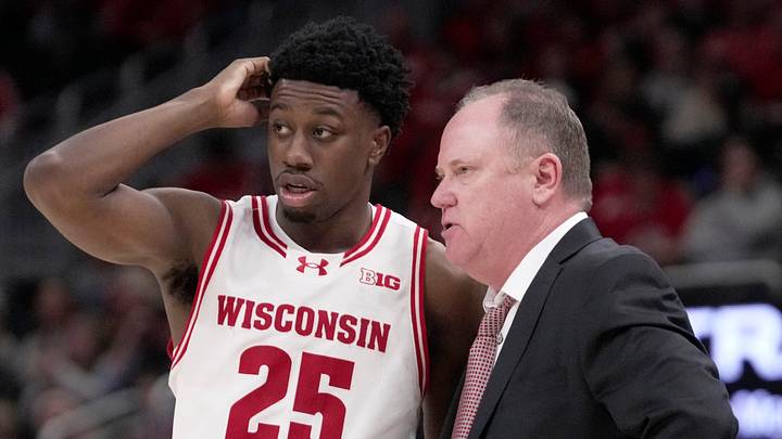 Wisconsin head coach Greg Gard talks with guard John Blackwell (25) during the second half of their game Friday, December 19, 2025 at Fiserv Forum in Milwaukee, Wisconsin. Villanova beat Wisconsin 76-66 in overtime.