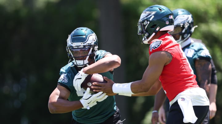 May 30, 2024; Philadelphia, PA, USA; Philadelphia Eagles quarterback Jalen Hurts (1) hands off to running back Saquon Barkley (26) during practice at NovaCare Complex.  