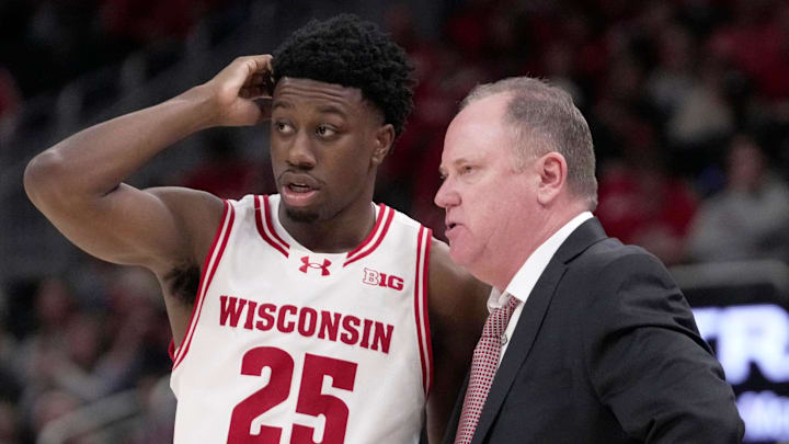 Wisconsin head coach Greg Gard talks with guard John Blackwell (25) during the second half of their game Friday, December 19, 2025 at Fiserv Forum in Milwaukee, Wisconsin. Villanova beat Wisconsin 76-66 in overtime.