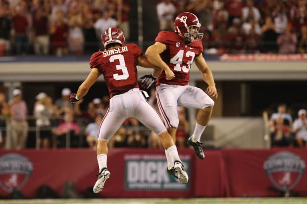 Alabama kicker Cade Foster (43) and safety Vinnie Sunseri (43) celebrate a field goal in a 41-14 victory over Michigan in 201