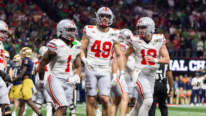Jan 20, 2025; Atlanta, GA, USA; Ohio State Buckeyes quarterback Will Howard (18) celebrates a touchdown with running back Quinshon Judkins (1) and tight end Patrick Gurd (49) against the Notre Dame Fighting Irish during the CFP National Championship college football game at Mercedes-Benz Stadium. Mandatory Credit: Mark J. Rebilas-Imagn Images