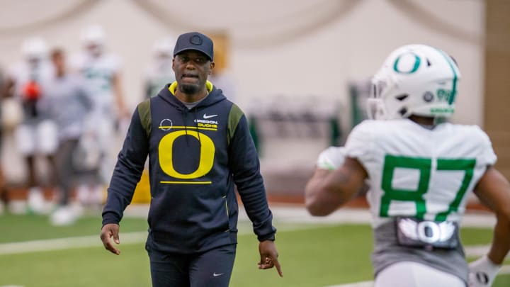 Oregon co-offensive coordinator and wide receivers coach Junior Adams leads a drill during practice at the Moshofsky Center in Eugene on Tuesday, April 12, 2022.