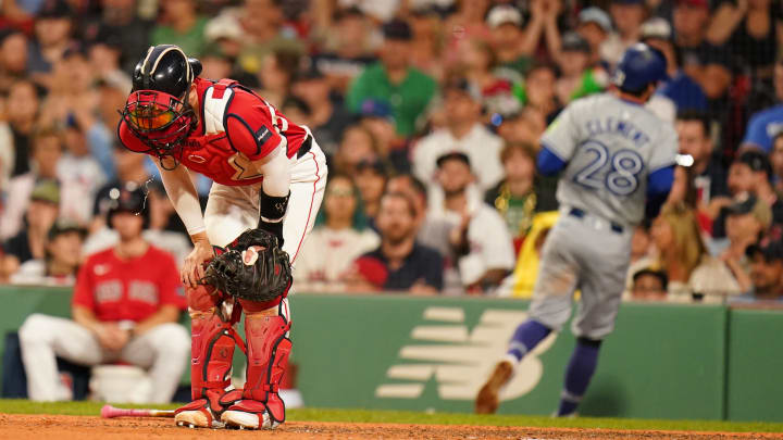 Aug 26, 2024; Boston, Massachusetts, USA; Boston Red Sox catcher Connor Wong (12) reacts after Toronto Blue Jays third baseman Ernie Clement (28) scores in the ninth inning at Fenway Park. Mandatory Credit: David Butler II-USA TODAY Sports