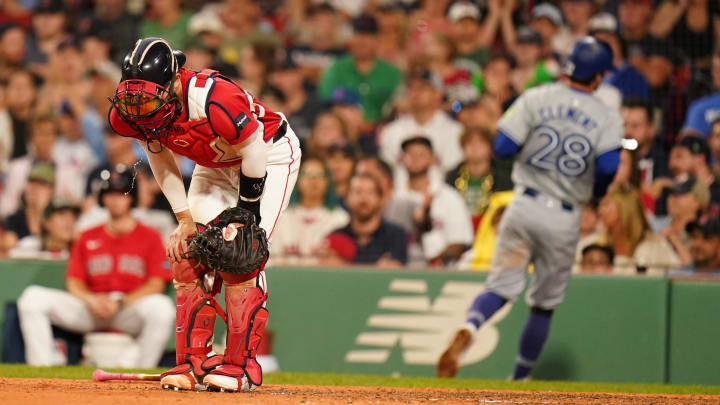 Aug 26, 2024; Boston, Massachusetts, USA; Boston Red Sox catcher Connor Wong (12) reacts after Toronto Blue Jays third baseman Ernie Clement (28) scores in the ninth inning at Fenway Park. Mandatory Credit: David Butler II-USA TODAY Sports