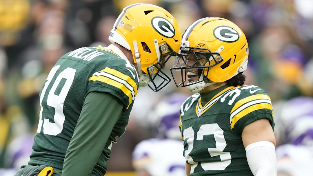 Nov 23, 2025; Green Bay, Wisconsin, USA; Green Bay Packers punter Daniel Whelan (19) and safety Evan Williams (33) react after a fumble recovery on a muffed punt by the Minnesota Vikings during the second half at Lambeau Field.